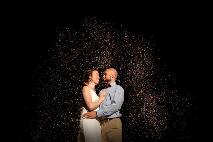 Newly married couple embracing in a field during their rustic outdoor wedding at Camp Hebron.
